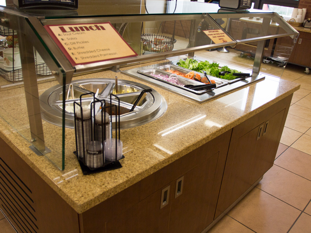 M-Power island food counter holding multiple food items.
